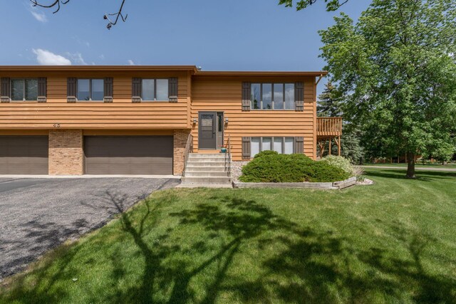 45 Restless Ct Unit 101, North Mankato, MN 56003 - bi-level home with a garage, a front lawn, driveway, and brick siding
