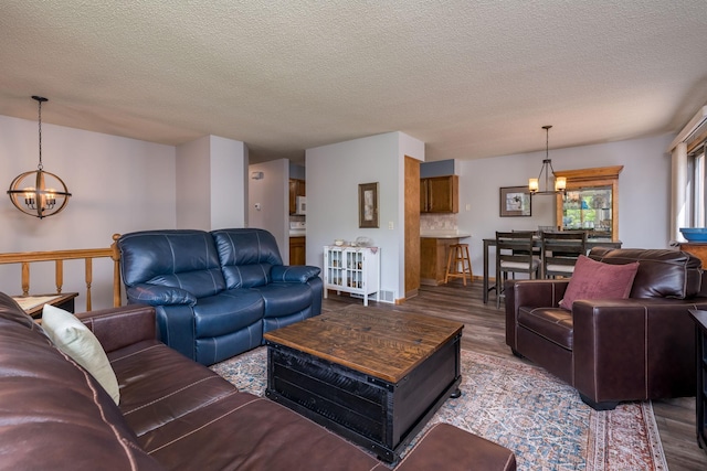 45 Restless Ct Unit 101, North Mankato, MN 56003 - living room with a chandelier, wood finished floors, and a textured ceiling