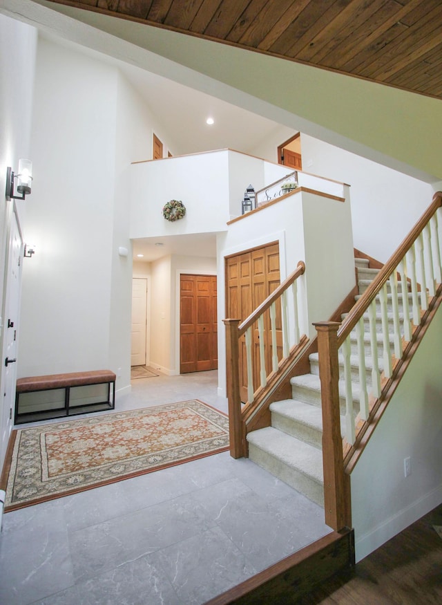 10551 Shore Dr, Merrifield, MN 56465 - entryway with baseboards, stairs, wooden ceiling, recessed lighting, and a high ceiling