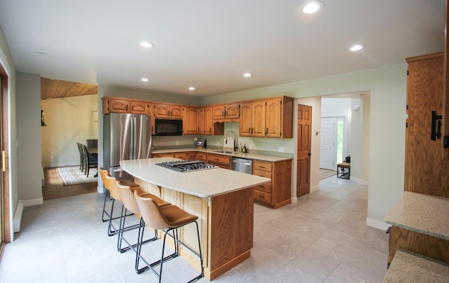 10551 Shore Dr, Merrifield, MN 56465 - kitchen with stainless steel appliances, a sink, light countertops, recessed lighting, and brown cabinets