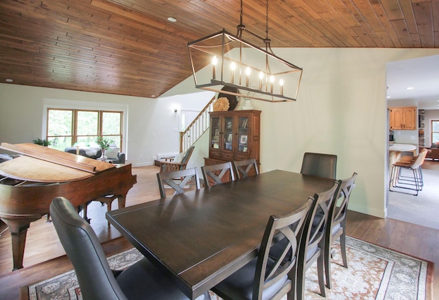 10551 Shore Dr, Merrifield, MN 56465 - dining room with vaulted ceiling, stairs, wood ceiling, baseboards, and light wood finished floors