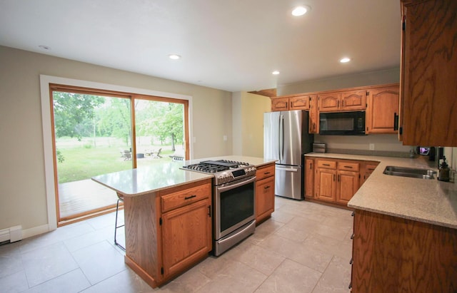 10551 Shore Dr, Merrifield, MN 56465 - kitchen with stainless steel appliances, light countertops, recessed lighting, a kitchen island, and light tile patterned flooring