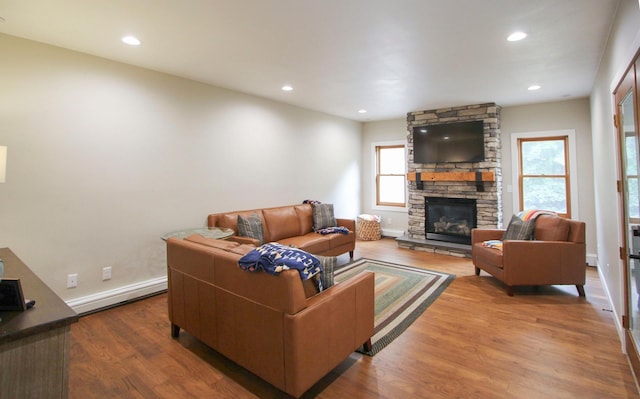 10551 Shore Dr, Merrifield, MN 56465 - living area with baseboard heating, wood finished floors, a fireplace, and recessed lighting