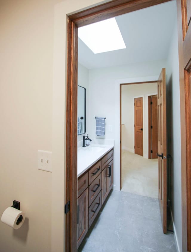 10551 Shore Dr, Merrifield, MN 56465 - bathroom featuring a skylight and double vanity