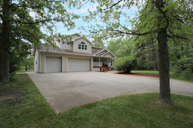 10551 Shore Dr, Merrifield, MN 56465 - view of front of home featuring concrete driveway, a porch, and an attached garage
