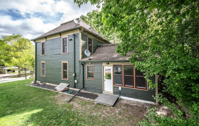 711 2nd St W, Northfield, MN 55057 - back of house with a yard and a shingled roof