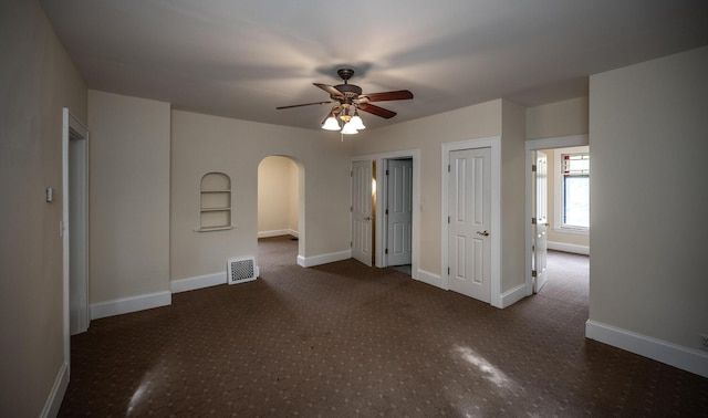 711 2nd St W, Northfield, MN 55057 - carpeted spare room with arched walkways, a ceiling fan, and baseboards