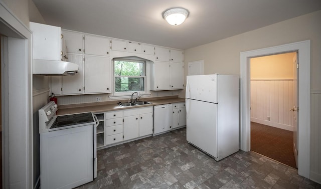 711 2nd St W, Northfield, MN 55057 - kitchen with white appliances, under cabinet range hood, white cabinetry, stone finish flooring, and a wainscoted wall