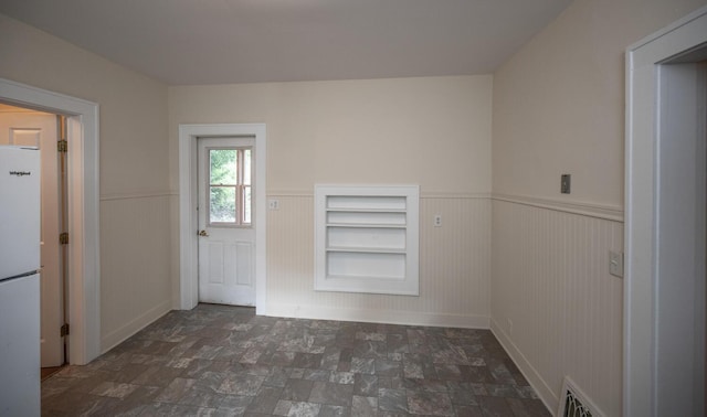 711 2nd St W, Northfield, MN 55057 - spare room featuring wainscoting and stone finish floors