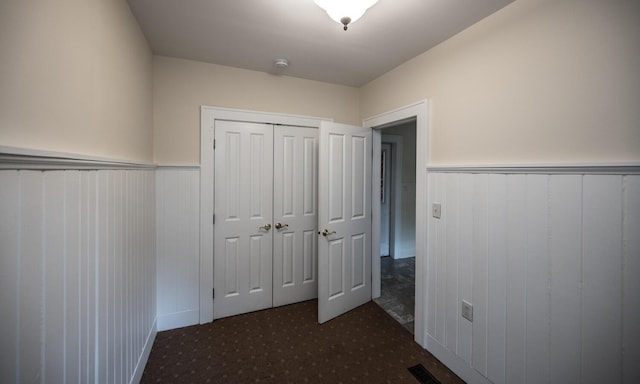 711 2nd St W, Northfield, MN 55057 - unfurnished bedroom featuring a wainscoted wall, carpet floors, and a closet