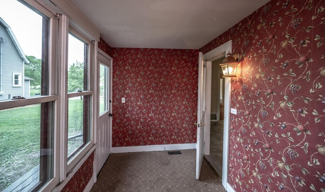 711 2nd St W, Northfield, MN 55057 - unfurnished sunroom featuring baseboards and carpet flooring