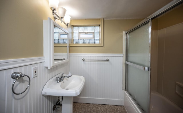 711 2nd St W, Northfield, MN 55057 - bathroom featuring wainscoting, enclosed tub / shower combo, and a sink