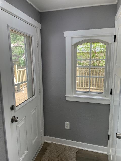 doorway to outside featuring baseboards and healthy amount of natural light