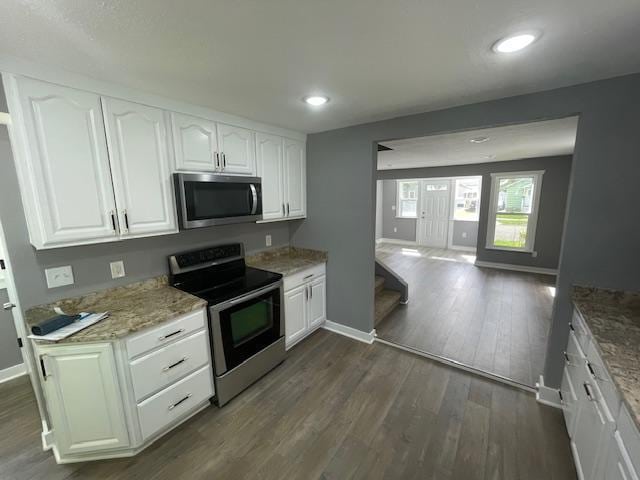 kitchen with stainless steel appliances, baseboards, white cabinets, light stone counters, and recessed lighting
