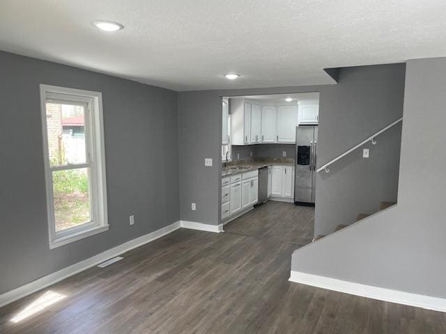 kitchen with stainless steel appliances, baseboards, white cabinets, dark wood-type flooring, and recessed lighting