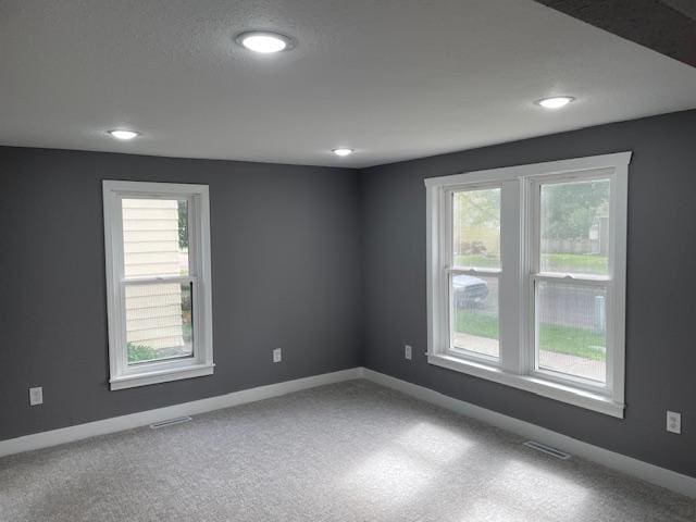 carpeted spare room with recessed lighting and baseboards