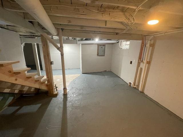 basement with stairway and electric panel