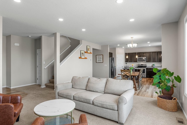 living area with recessed lighting, stairway, a chandelier, light carpet, and baseboards
