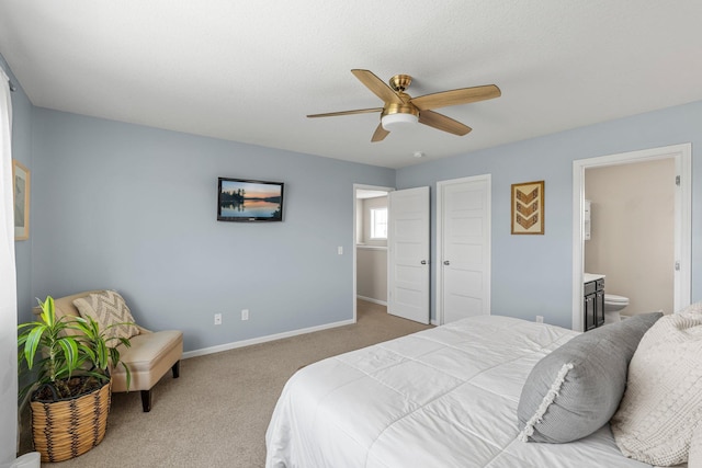 bedroom with carpet, baseboards, ensuite bathroom, and ceiling fan