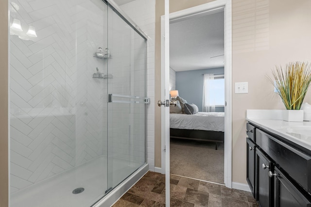 bathroom with a stall shower, ensuite bathroom, and baseboards