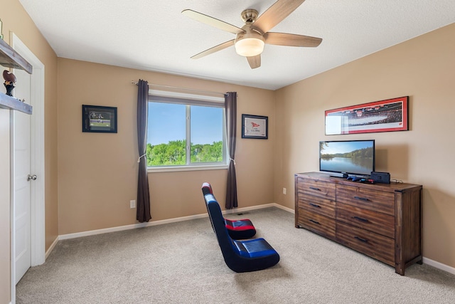 bedroom featuring light colored carpet, baseboards, and ceiling fan