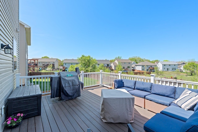 wooden deck with an outdoor living space, a residential view, and area for grilling