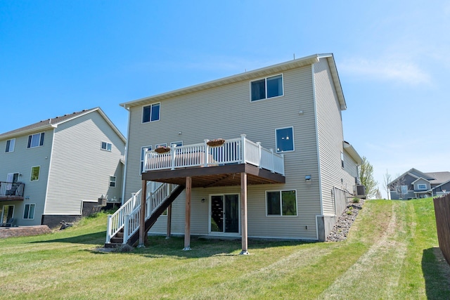 rear view of house featuring a wooden deck, stairway, and a yard
