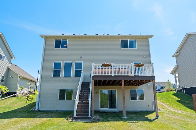 rear view of property featuring stairs, a deck, and a lawn