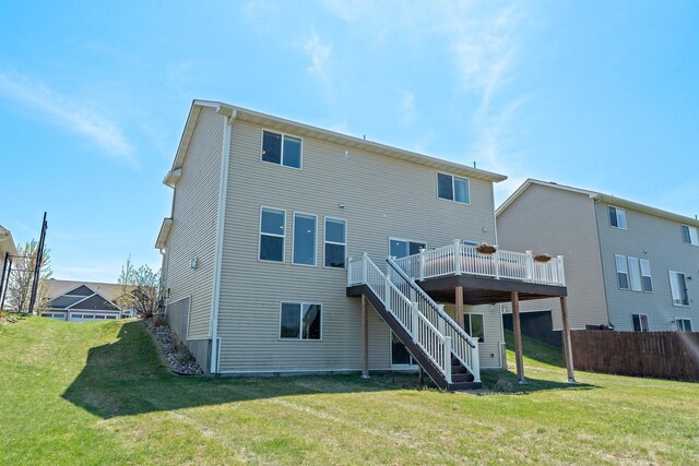 back of property featuring stairway, a wooden deck, and a lawn