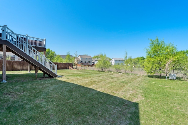 view of yard with stairway and a deck