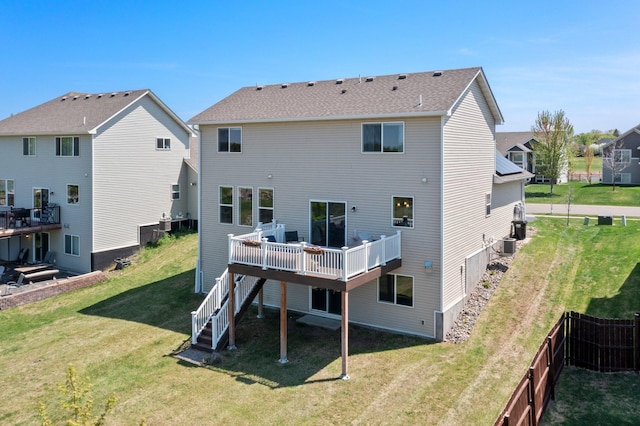 rear view of property featuring a wooden deck