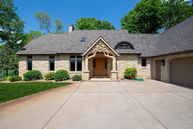 4214 Fairview Ln, Jamestown Twp, MN 56063 - view of front of home with stone siding, roof with shingles, a chimney, and driveway