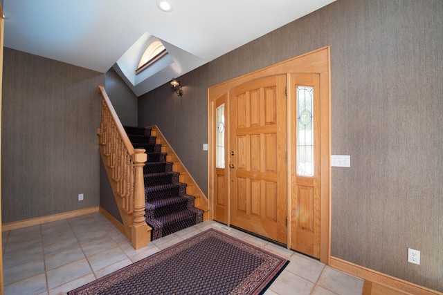 4214 Fairview Ln, Jamestown Twp, MN 56063 - entryway with stairs, light tile patterned floors, a skylight, baseboards, and wallpapered walls