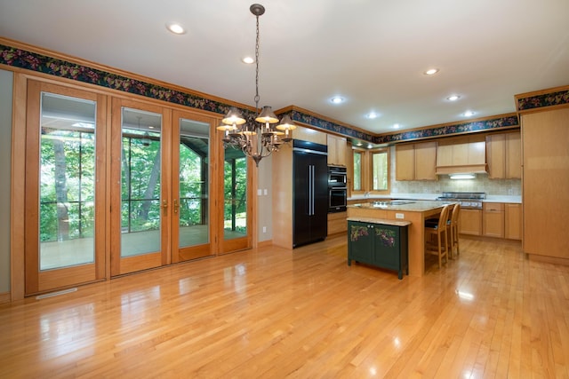 4214 Fairview Ln, Jamestown Twp, MN 56063 - kitchen with a chandelier, built in refrigerator, a center island, light wood finished floors, and decorative backsplash