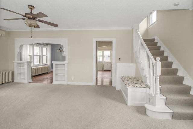 139 Annapolis St E, Saint Paul, MN 55118 - staircase featuring radiator heating unit, carpet, ornamental molding, ceiling fan, and baseboards