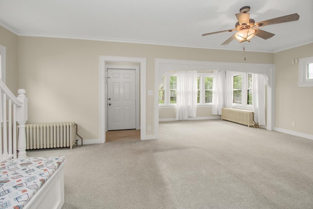 139 Annapolis St E, Saint Paul, MN 55118 - unfurnished living room with radiator heating unit, crown molding, carpet flooring, ceiling fan, and baseboards