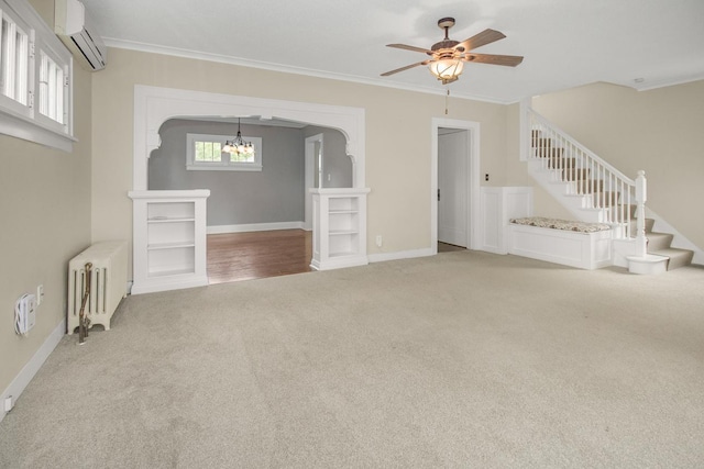 139 Annapolis St E, Saint Paul, MN 55118 - unfurnished living room featuring radiator heating unit, light carpet, an AC wall unit, crown molding, and stairs