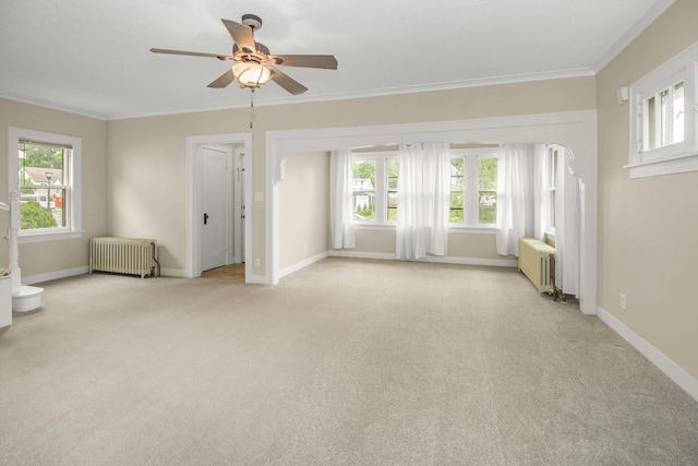 139 Annapolis St E, Saint Paul, MN 55118 - unfurnished room featuring radiator heating unit, a ceiling fan, light colored carpet, and crown molding