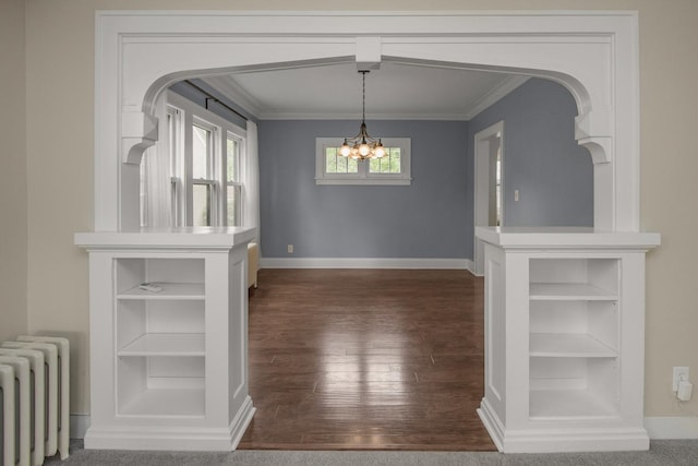 139 Annapolis St E, Saint Paul, MN 55118 - unfurnished dining area with radiator, crown molding, plenty of natural light, dark wood finished floors, and a chandelier