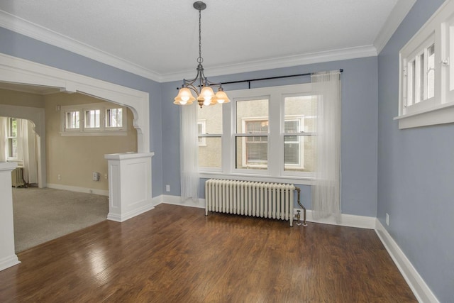 139 Annapolis St E, Saint Paul, MN 55118 - unfurnished dining area with radiator, arched walkways, a chandelier, wood finished floors, and crown molding