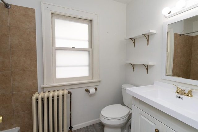 139 Annapolis St E, Saint Paul, MN 55118 - bathroom with radiator, vanity, a shower, toilet, and baseboards