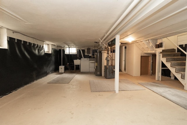139 Annapolis St E, Saint Paul, MN 55118 - below grade area featuring water heater, stairs, a sink, and separate washer and dryer