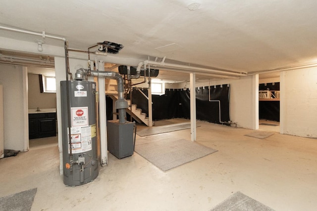 139 Annapolis St E, Saint Paul, MN 55118 - basement featuring gas water heater, stairway, and a sink