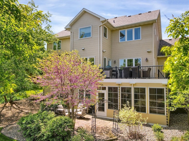 2907 Cougar Path NW, Prior Lake, MN 55372 - back of house featuring a balcony, a patio area, and a shingled roof