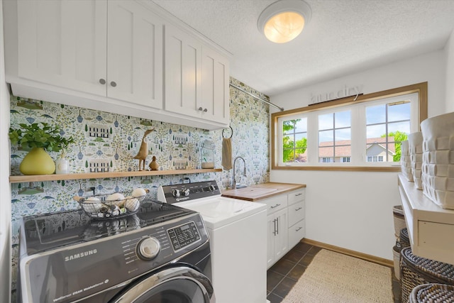 2907 Cougar Path NW, Prior Lake, MN 55372 - laundry area featuring cabinet space, washing machine and dryer, dark tile patterned flooring, a textured ceiling, and baseboards