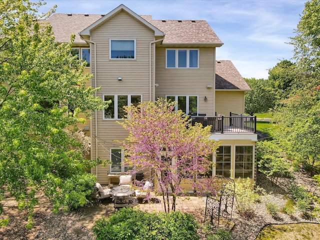 2907 Cougar Path NW, Prior Lake, MN 55372 - rear view of property with a shingled roof, a patio, and a balcony