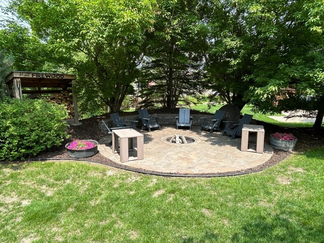 2907 Cougar Path NW, Prior Lake, MN 55372 - view of grassy yard featuring an outdoor fire pit and a patio area