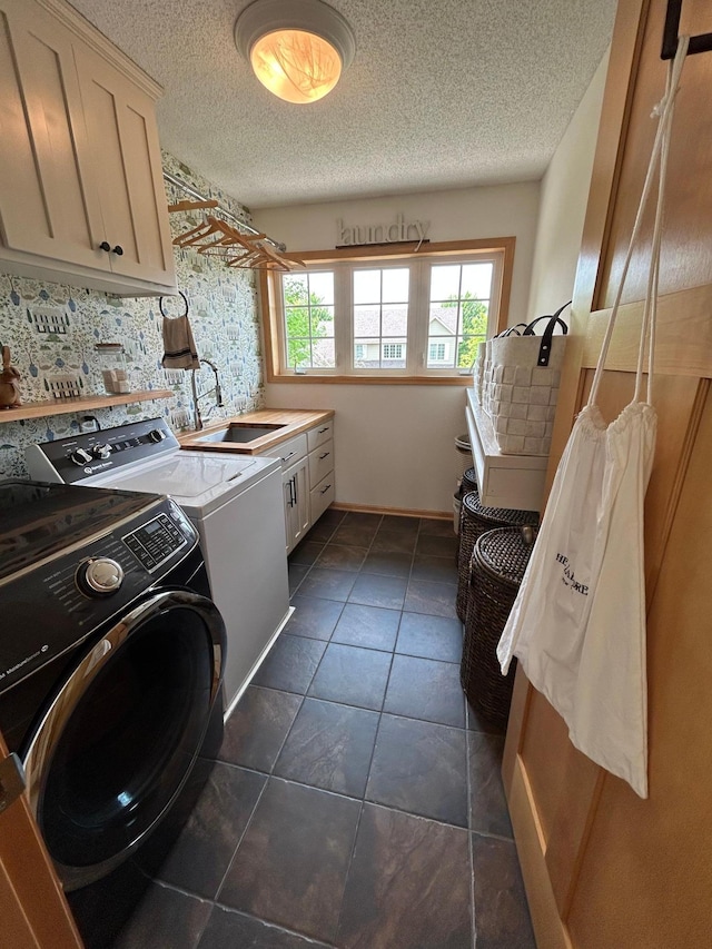 2907 Cougar Path NW, Prior Lake, MN 55372 - washroom featuring cabinet space, independent washer and dryer, a textured ceiling, and dark tile patterned floors