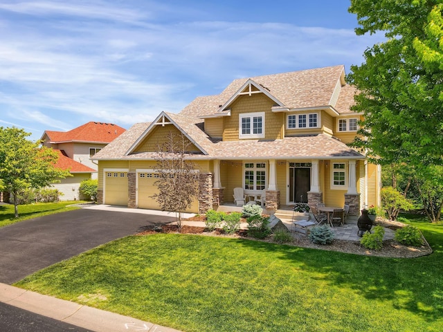 2907 Cougar Path NW, Prior Lake, MN 55372 - craftsman house with a porch, a front yard, asphalt driveway, an attached garage, and stone siding