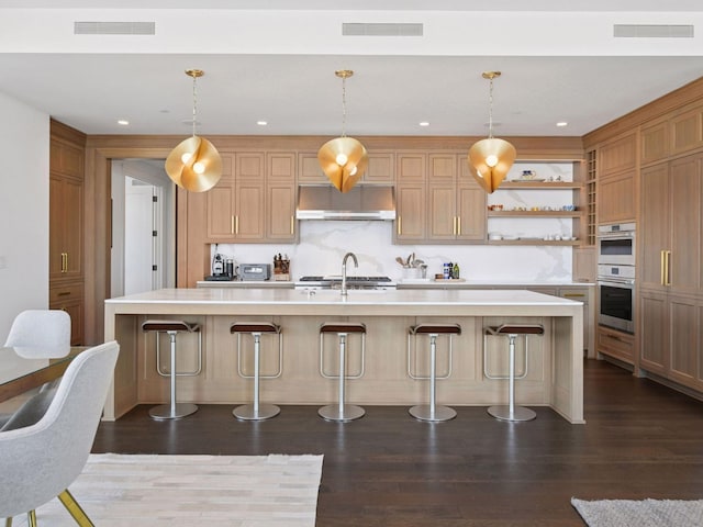 1111 River Pkwy Unit 33A, Minneapolis, MN 55415 - kitchen featuring under cabinet range hood, light countertops, open shelves, dark wood-style floors, and double oven